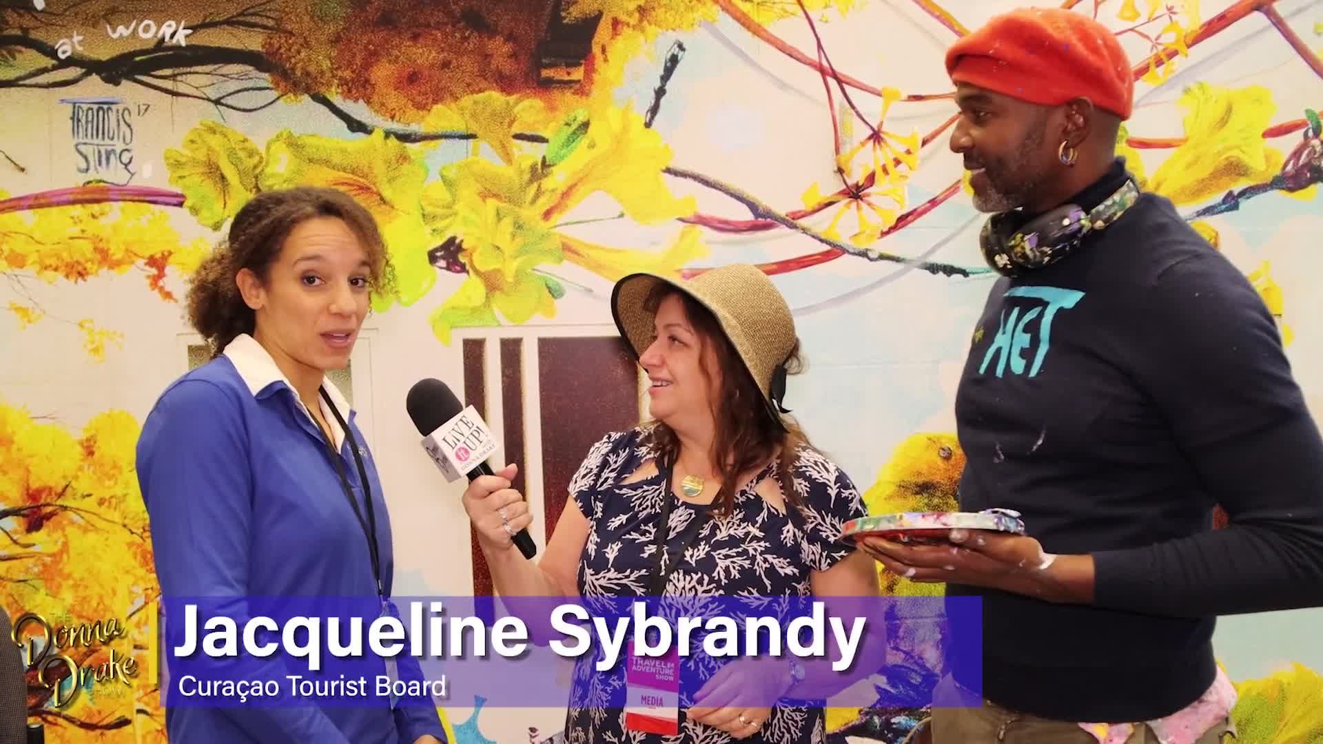 The Donna Drake Show travels to the Curaçao booth and paints with Francis Sling