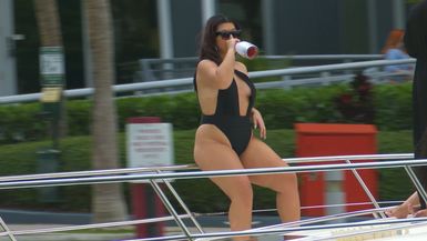 Bubbly Bliss: Lady Enjoys a Champagne Cruise, Sipping Delight on a Miami Yacht Ride! 🥂🚤✨